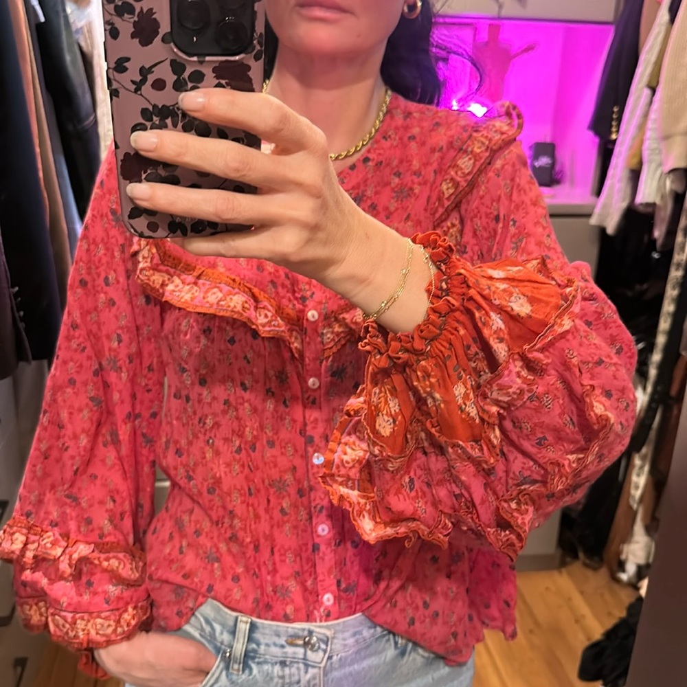 Hot pink floral button up blouse with ruffled sleeves.